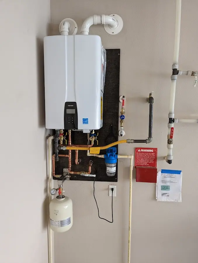 Professional plumber installing copper piping in a Huber Heights home